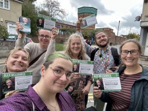 A group of green leafletters holding calling cards